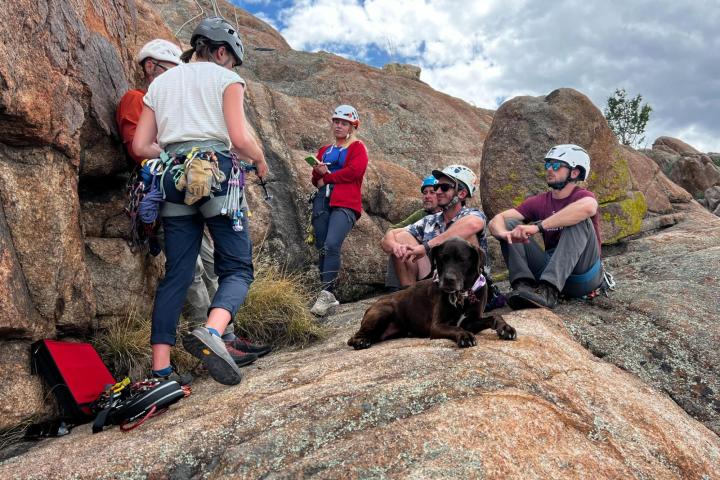 a group of people sitting on a rock